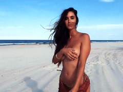 Gorgeous young model flaunts her perfect curves on the beach