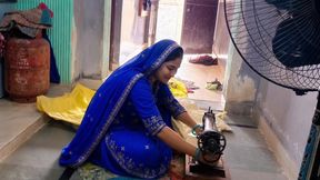 Indian wife sewing on the machine but she has other thoughts too.