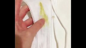 Girl shows dirty piss-stained panties with yellow urine stains and masturbates unwashed pussy close-up