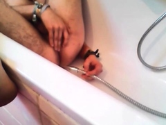 Bi-guy using shower head, squirting water, enema