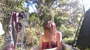 her body drips in the rain, skin glowing under the harsh light