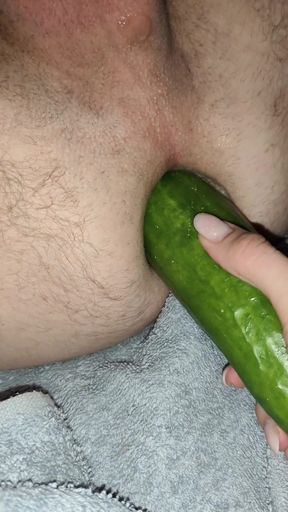 My wife is fucking my ass with a huge cucumber.