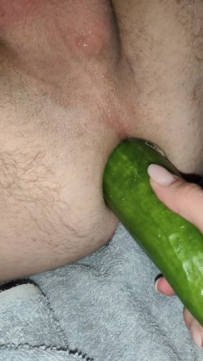 My wife is fucking my ass with a huge cucumber.