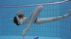 Tiny teen Anna gets wet in a poolside solo scene