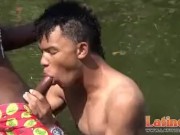 Teen gay swimmer playfully going down in the river