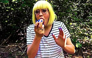 Blonde trans girl deepthroats vibrator outside