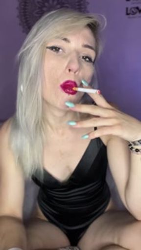 sexy blonde girl with red lipstick smokes a cigarette