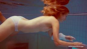 ”In the indoor pool, a beautiful chick swims”