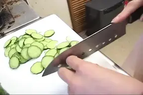 Insatiable housewife drenches cucumber in kitchen sink