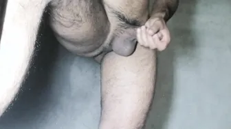 Solo bear strokes his soft cock in the bathroom