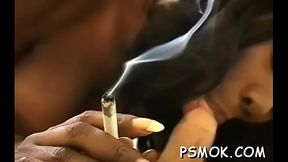 Inviting slut in see-through clothing smokin'_ a cigarette