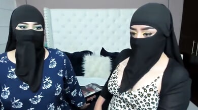 Two masked Arab women share an intimate lesbian cam session
