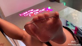 Goddess sexy feet close-up in torn sweaty nylons on the table