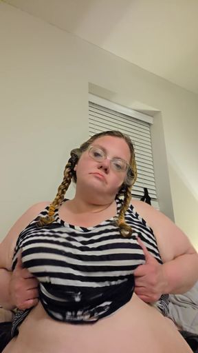 Curvy blonde woman in black and white striped top