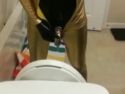 Peeing through chastity in catsuits