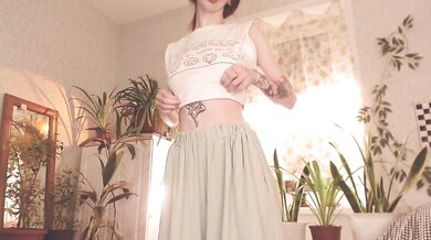 Tattooed beauty teases in pyjamas dancing in long skirt