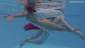 Girlfriends enjoy swimming naked together