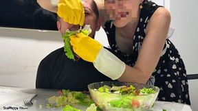 Yellow Gloved Mistress Stuffing His Mouth with Salad