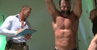 Two men with great bodies are tormenting a muscular lad