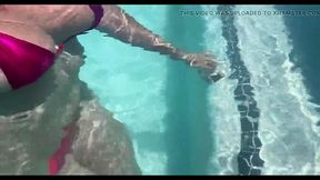 Sexy MILF shows off huge natural tits underwater