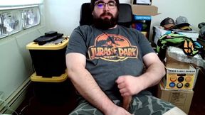 Bear in boxers strokes hard while jerking off to Jurassic Park on his computer chair