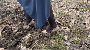 Cut of clips of a girl getting her high heels dirty in the mud