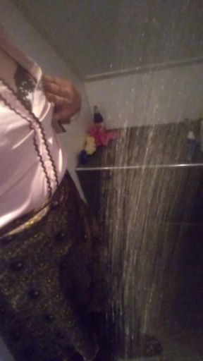 Crossdresser in satijn blouse under the shower