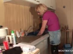 Mature housekeeper teasing her hot snatch in the kitchen
