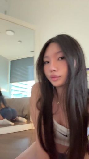 Slim solo girl performs squats while juggling her thick cock. She