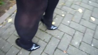 Strutting in my black patent leather high-heeled stilettos.