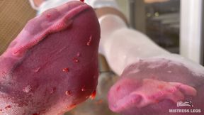 My Nylon Feet Squeezing Strawberry Juice on a Glass Table