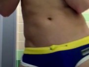Athletic twink in swim trunks