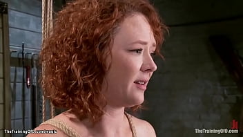 Redheaded slave trainee Audrey Hollander gets anal buttplug and whip play
