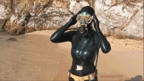 Sexy blonde girl in black latex catsuit diving in sea