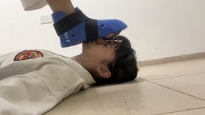 Female sparring with footpads to face