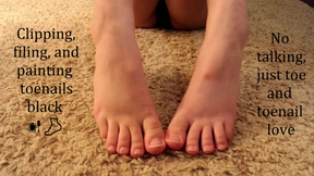 Clipping, filing and painting toenails black