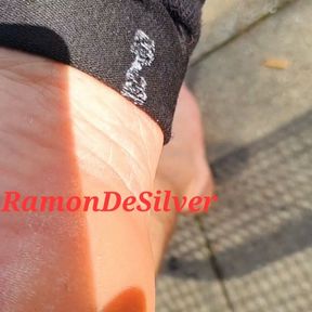 Master Ramon takes off his sweaty shoes and socks and walks barefoot through the damp grass