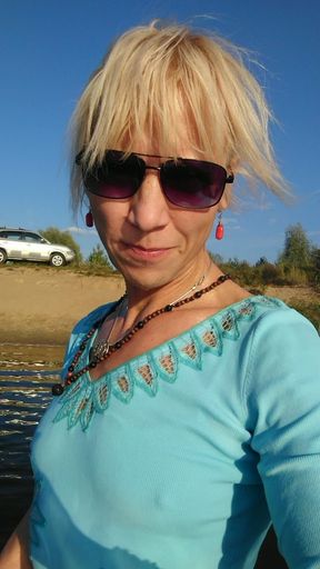 Trans Girl Swimming in the Lake in Clothes Blue Blouse and White-milk Pants.