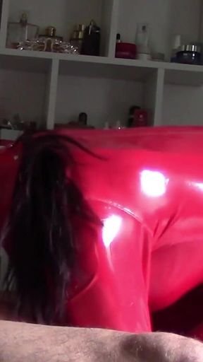 MILF in Red Latex Suit and Patent Leather High Heels Gives a Blowjob with Swallow
