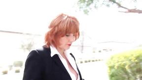 ”Ginger chubby mature making up in office gear”