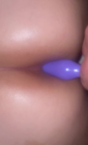 Close-up of a blue vibrator in a woman's mouth