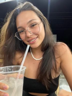Woman drinking from straw in public