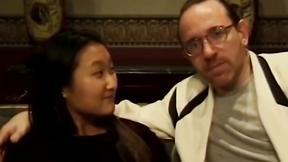 ”Sensual Asian teen has her booty banged by two guys on couch”