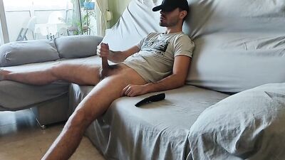 Horny straight bloke is jerking his prick while watching a TV