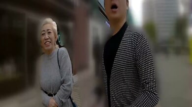 Blonde middle-aged woman receives oral from young Asian man in hotel