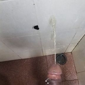 Pissing on the wall, man cock dripping