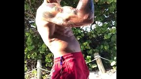 BICEP FLEXING AT THE BEACH