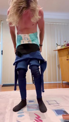 Wet swimsuit babe plays with her diaper bodysuit in petplay