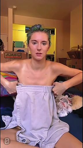Flustered girl accidentally exposes a nipslip while standing alone