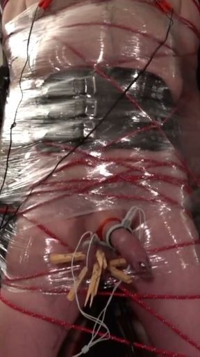 Frankenslave is suspended in cling film bondage with electro play in the dungeon of Lady Diva Cane   Clip 1